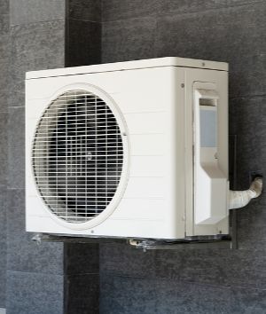Ductless mini split air conditioning unit attached to a wall.