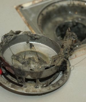 Technician repairing a clogged drain