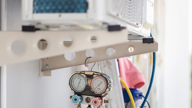 Outdoor air conditioning unit with equipment to gauge its functionality.