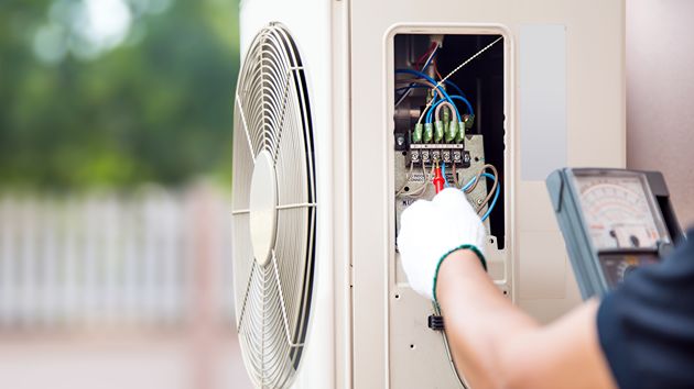 How Long Does AC Installation Take? Technician installing a new air conditioning unit.